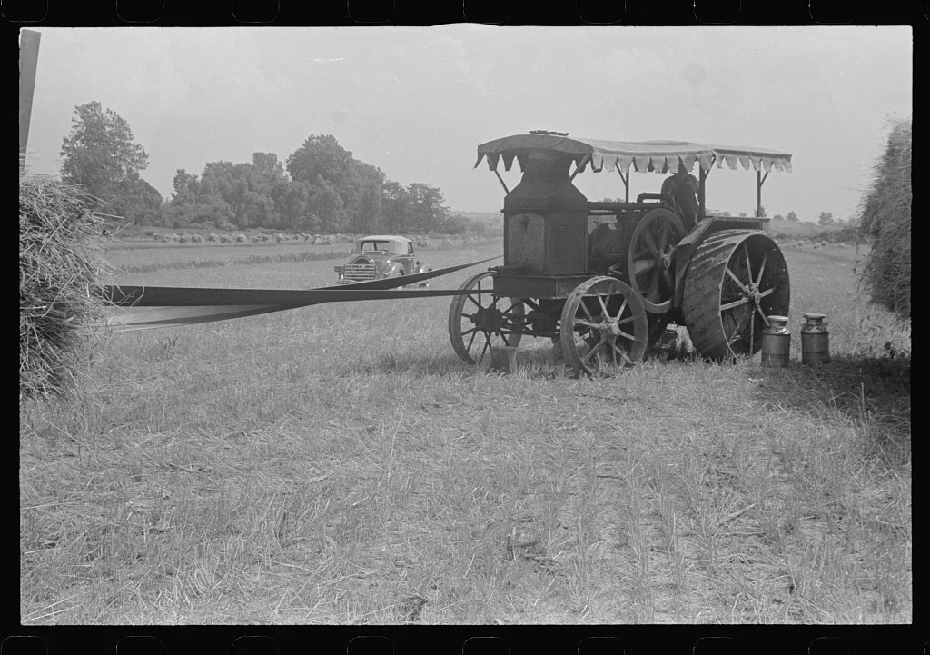 Gasoline tractor furnishing power for threshing, central Ohio, 1938