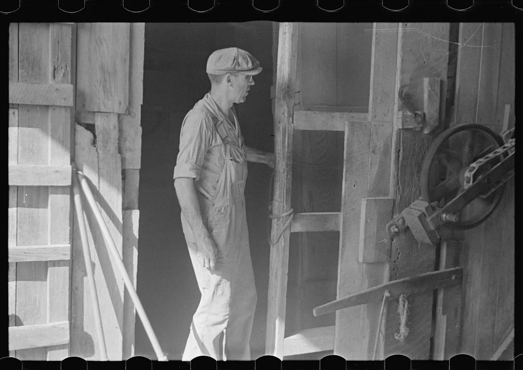 [Untitled photo, possibly related to: Unloading truck inside grain…, Ohio, 1938