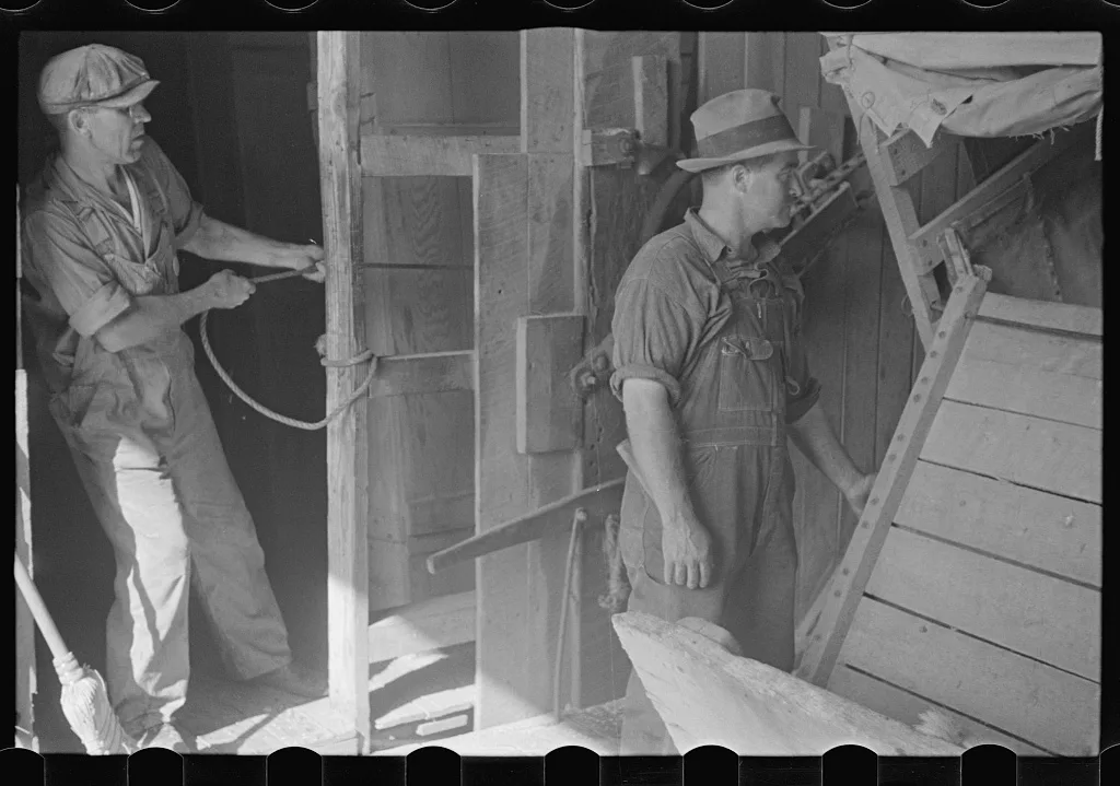 [Untitled photo, possibly related to: Unloading truck inside grain…, Ohio, 1938