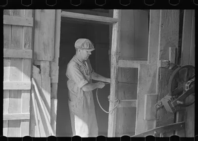 [Untitled photo, possibly related to: Unloading truck inside grain…, Ohio, 1938
