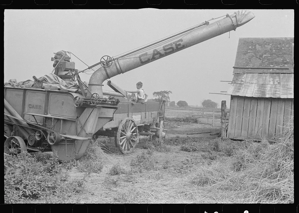 [Untitled photo, possibly related to: Adjusting straw stocker on…, Ohio, 1938