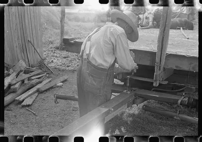 Farmer repairing wagon, central Ohio, 1938