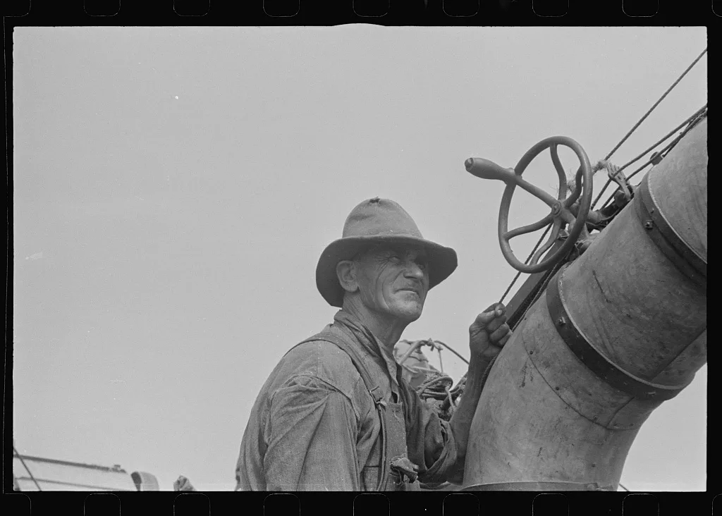 [Untitled photo, possibly related to: Adjusting straw stacker or…, Ohio, 1938
