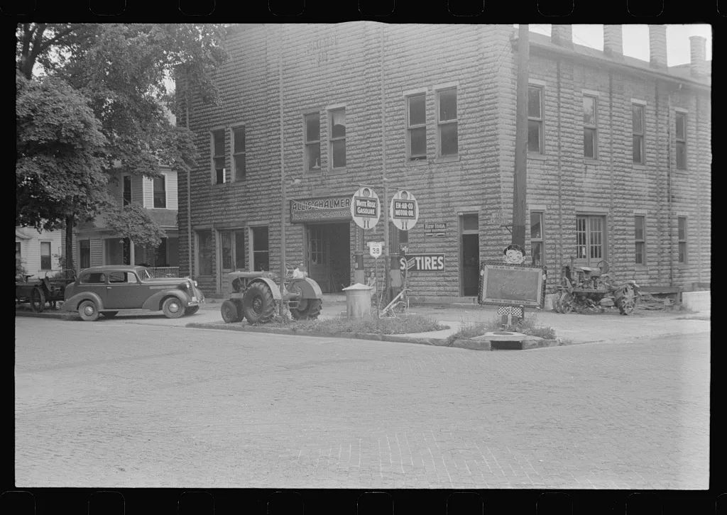 The backyard of this gas station is a farm machinery graveyard,…, Ohio, 1938