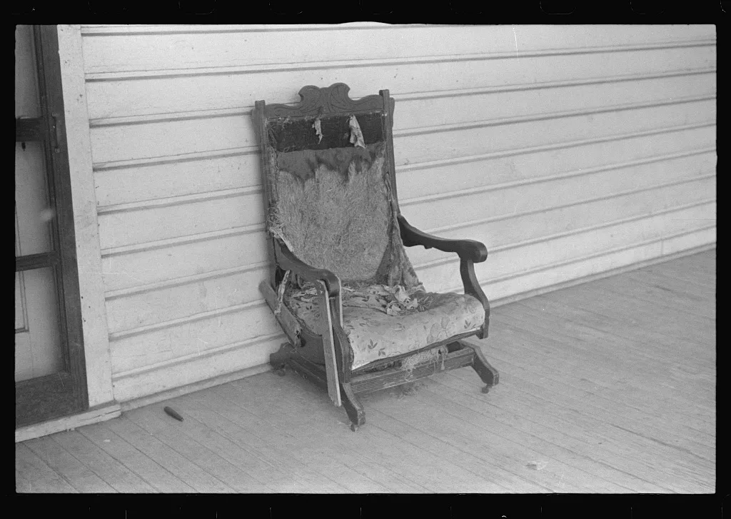 Dilapidated chair on porch at farmland auction, New Carlisle [i.e.…, Ohio, 1938