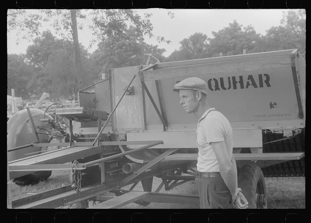Attendant at farm machine display at county fair, central Ohio, 1938