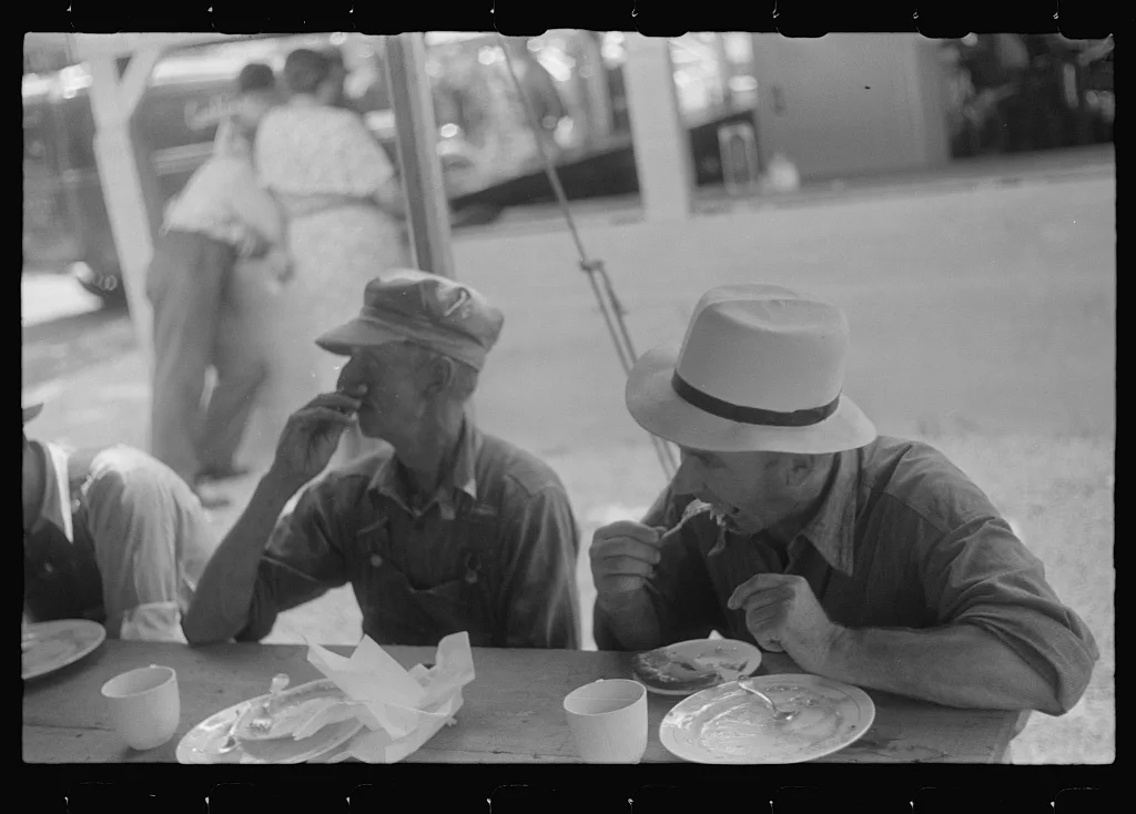 Spectators at county fair eating lunch, central Ohio, 1938