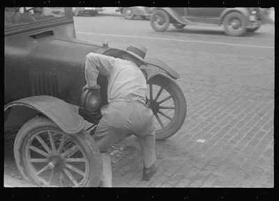 Cranking car to get it started, the old way, Worthington, Ohio, 1938