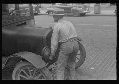 Cranking Model "T" Ford before the days of the self-starter,…, Ohio, 1938