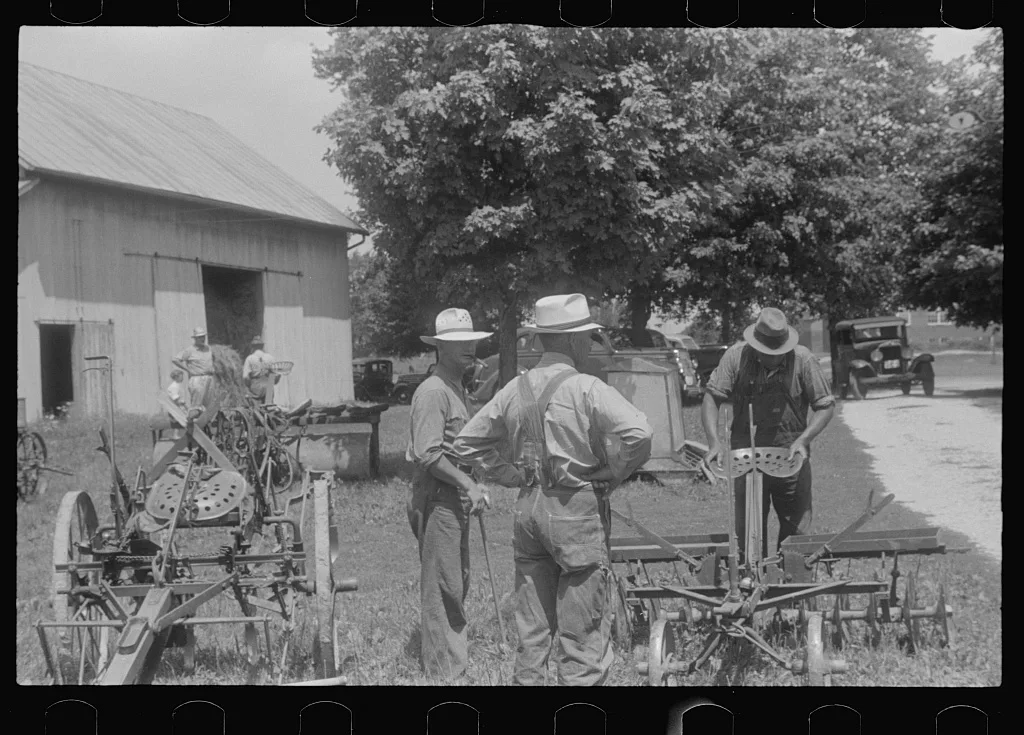 Inspecting farm machinery at public auction, central Ohio, 1938