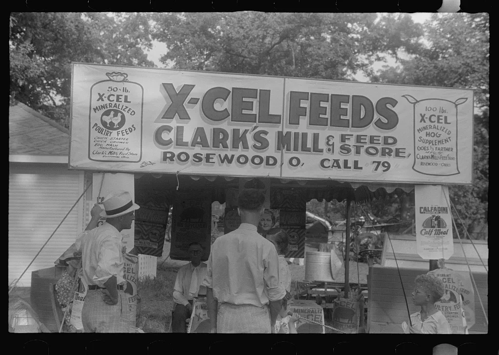 Advertising feeds at county fair, central Ohio, 1938