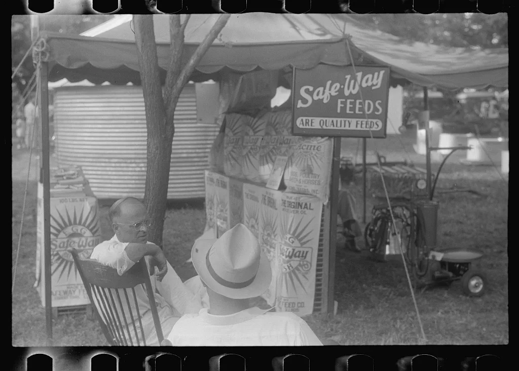 Advertising feeds at county fair, central Ohio, 1938