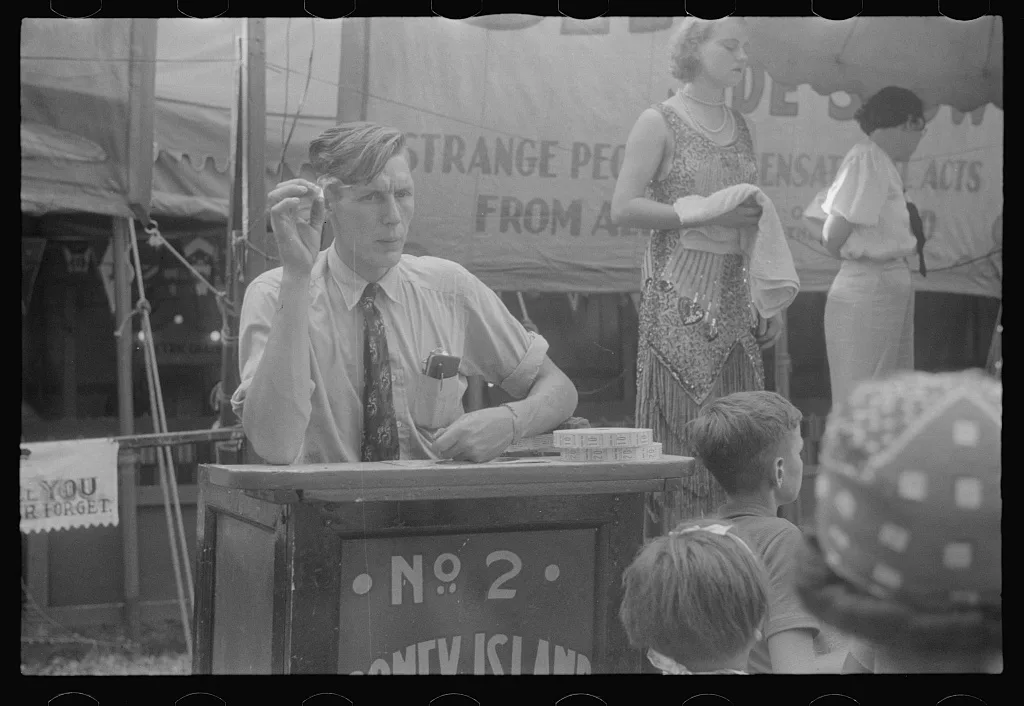 Selling tickets to the sideshow, county fair, central Ohio, 1938