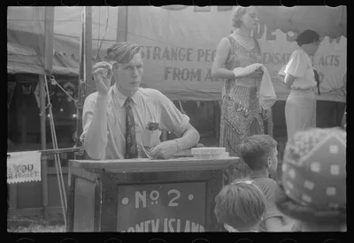 Selling tickets to the sideshow, county fair, central Ohio, 1938